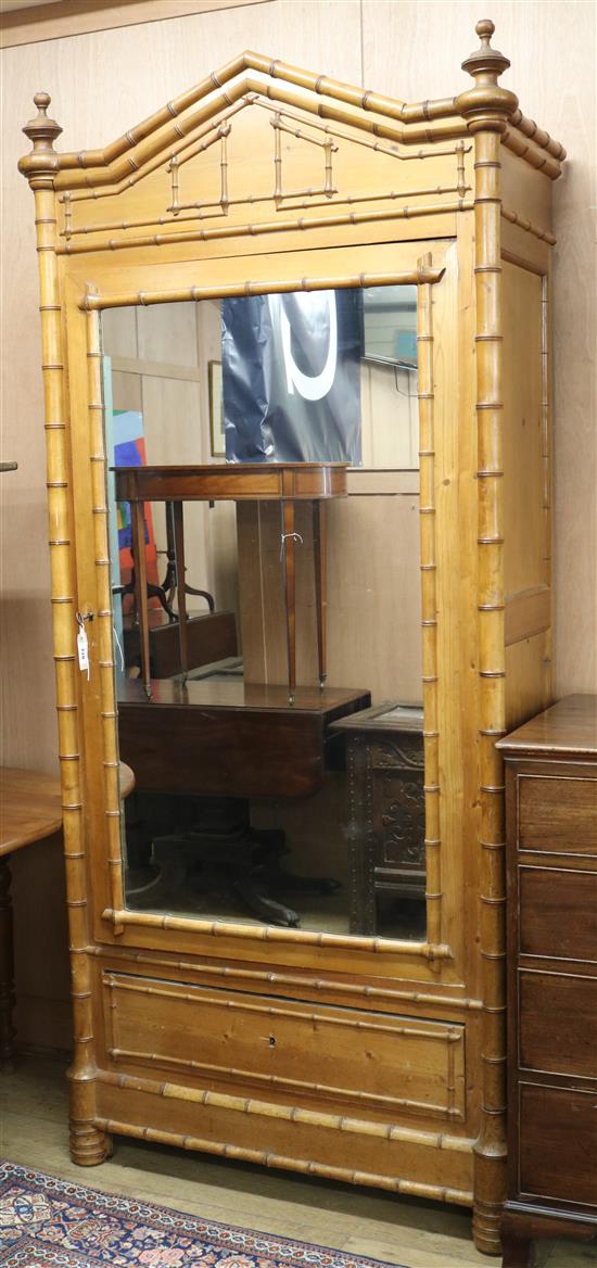 A faux bamboo mirrored cabinet with shelves W.100cm approx.